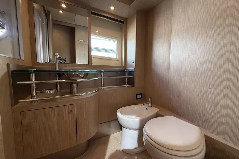 "alin 4ever" Yacht Photos Pics Luxurious bathroom interior of 2010 Riva 68 Ego Super yacht, featuring modern fixtures and wood paneling.