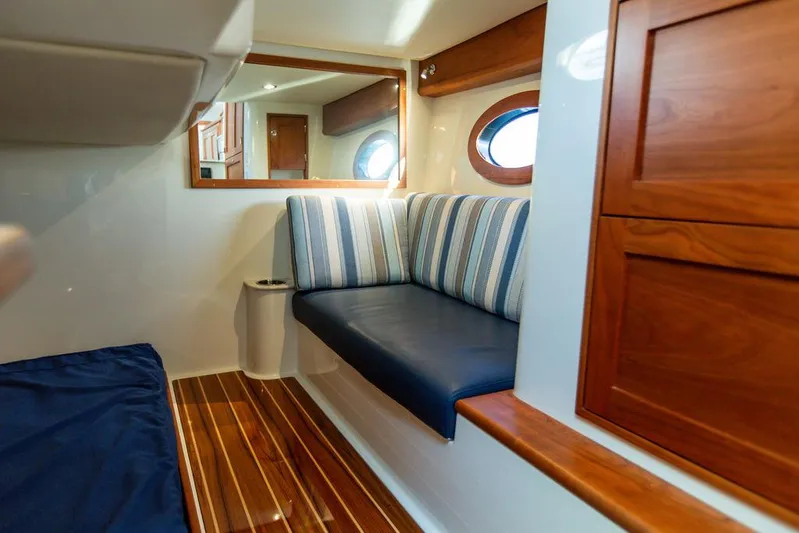 Cavu 4 Yacht Photos Pics Interior of 2022 Hinckley Sport Boat 40 X with striped seating and wooden accents.