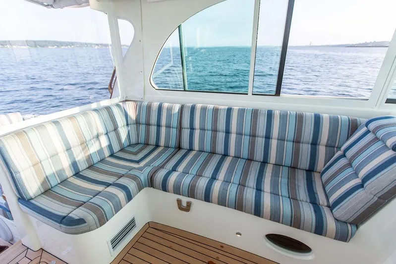 Cavu 4 Yacht Photos Pics 2022 Hinckley Sport Boat 40 X interior with striped seating and ocean view.