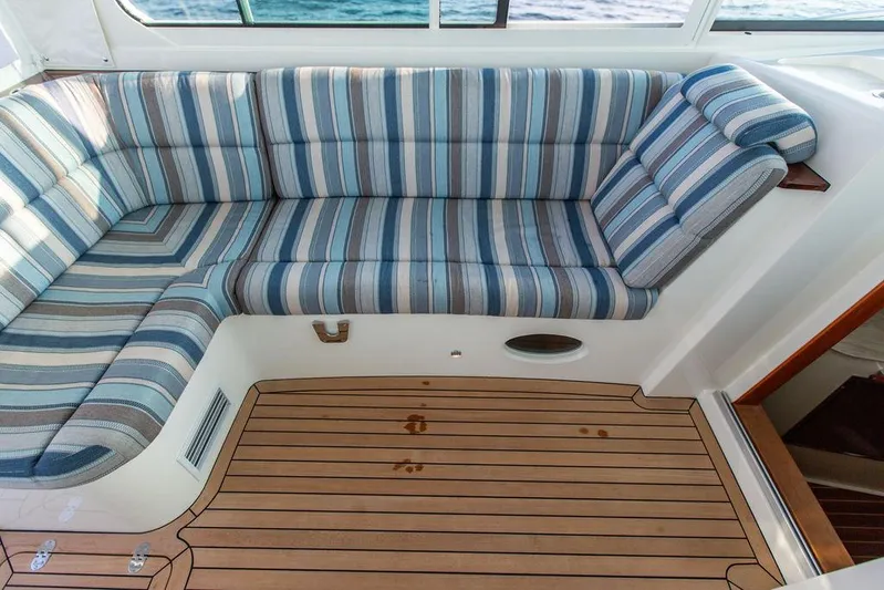 Cavu 4 Yacht Photos Pics 2022 Hinckley Sport Boat 40 X interior with striped seating and wooden flooring.