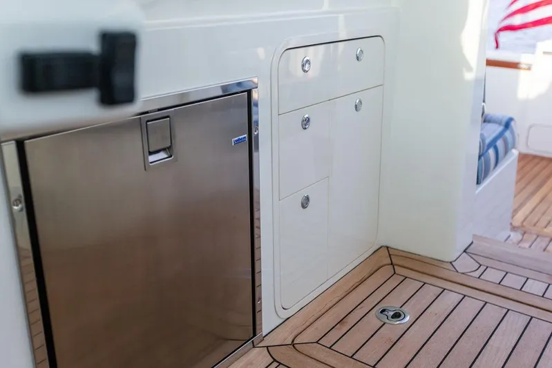 Cavu 4 Yacht Photos Pics Hinckley Sport Boat 40 X 2022 interior with stainless steel fridge and wooden flooring.