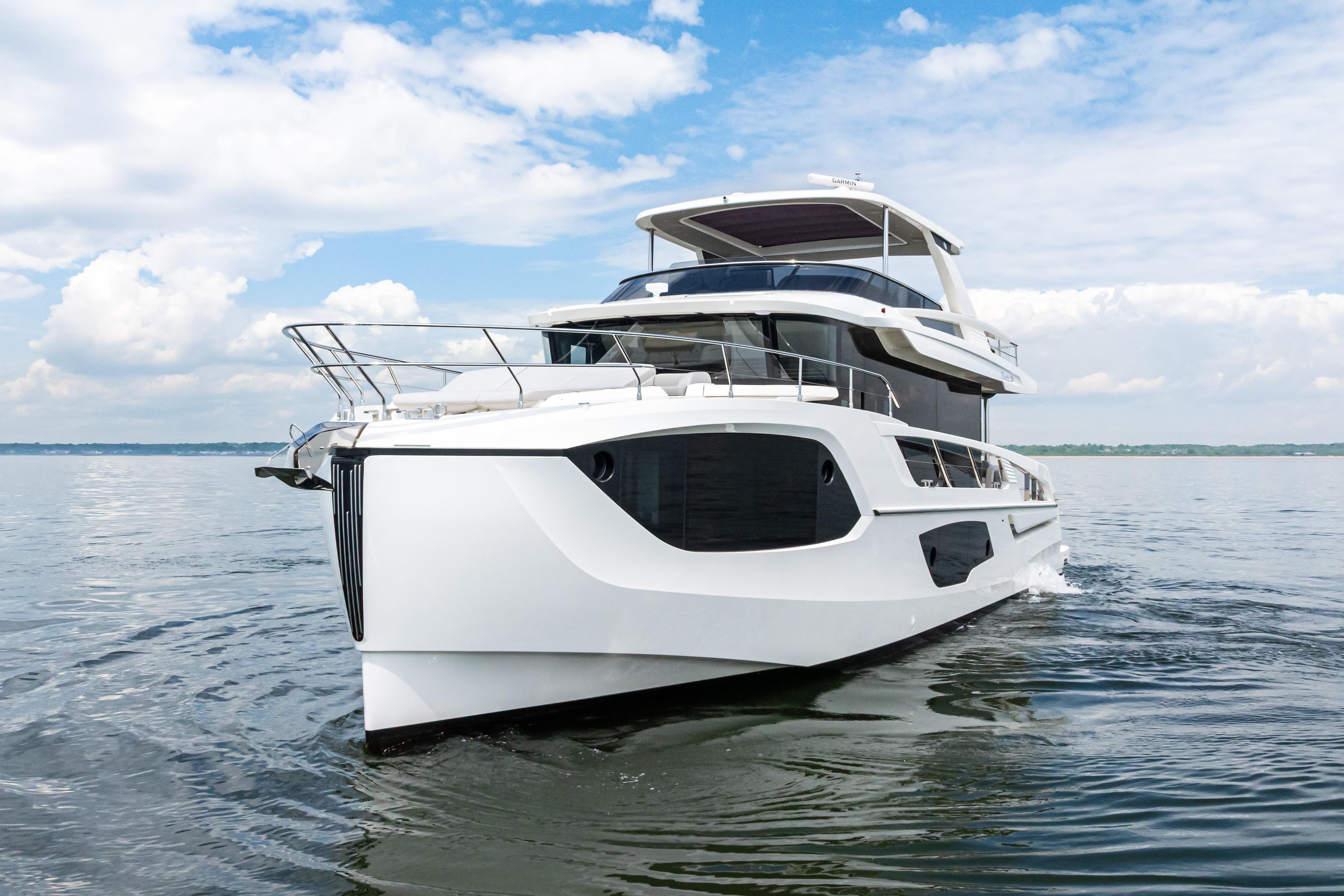 2025 Absolute Navetta 64 yacht cruising on calm waters under a blue sky.