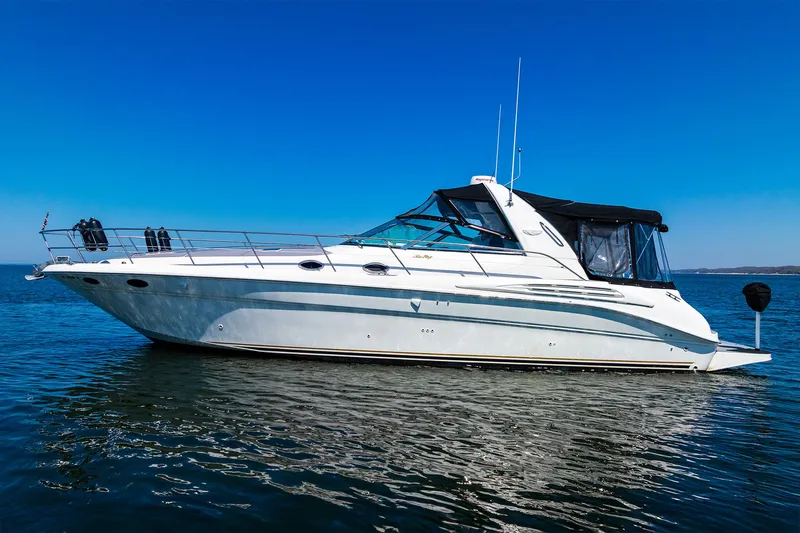  Yacht Photos Pics 1997 Sea Ray 400 Sundancer yacht on calm water under clear blue sky.