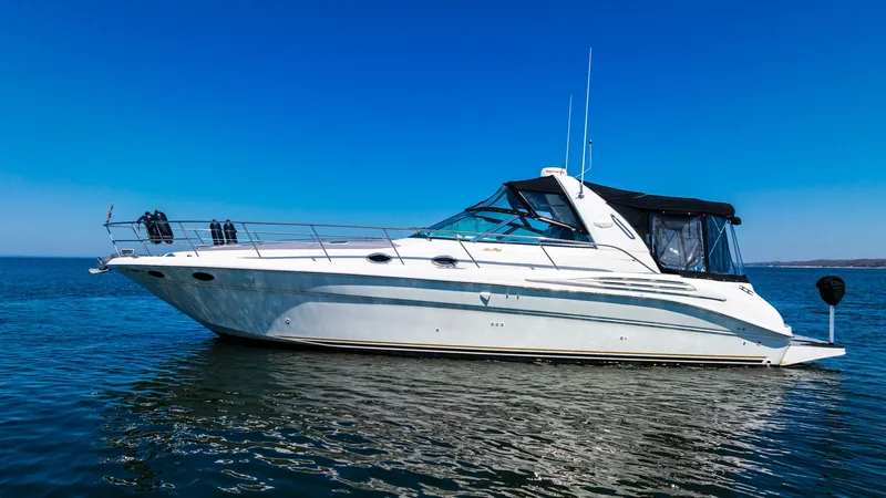  Yacht Photos Pics 1997 Sea Ray 400 Sundancer yacht on calm water under clear blue sky.