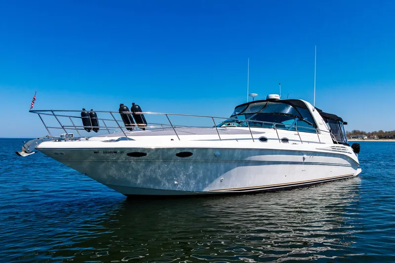  Yacht Photos Pics 1997 Sea Ray 400 Sundancer yacht on calm water under clear blue sky.
