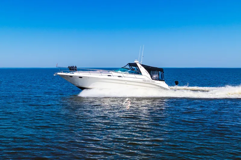  Yacht Photos Pics 1997 Sea Ray 400 Sundancer cruising on open water under clear blue sky.