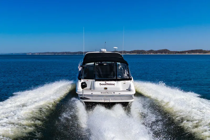  Yacht Photos Pics 1997 Sea Ray 400 Sundancer cruising on open water under clear blue skies.