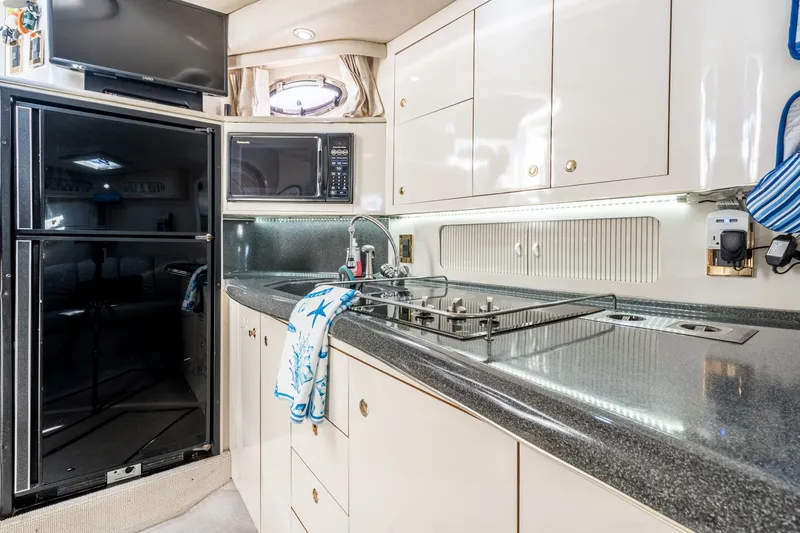  Yacht Photos Pics Luxurious kitchen interior of 1997 Sea Ray 400 Sundancer yacht with modern amenities.