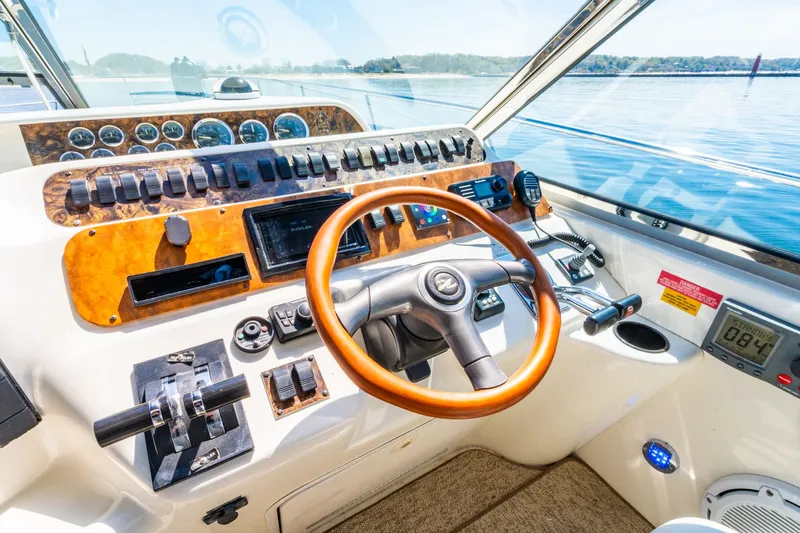  Yacht Photos Pics Cockpit of 1997 Sea Ray 400 Sundancer with wooden steering wheel and control panel.