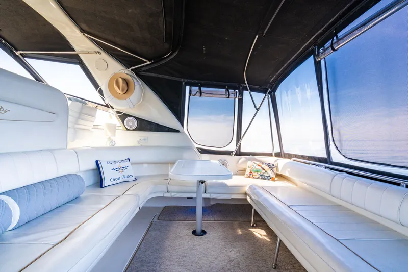  Yacht Photos Pics Luxurious interior of 1997 Sea Ray 400 Sundancer yacht with white seating and decorative pillows.