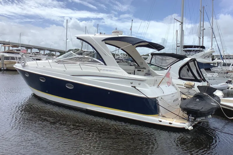 Perseides Yacht Photos Pics 2005 Regal Commodore 3860 yacht docked in a marina under a partly cloudy sky.