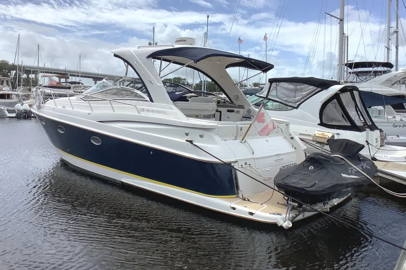 Perseides Yacht Photos Pics 2005 Regal Commodore 3860 yacht docked at marina, featuring sleek design and Canadian flag.