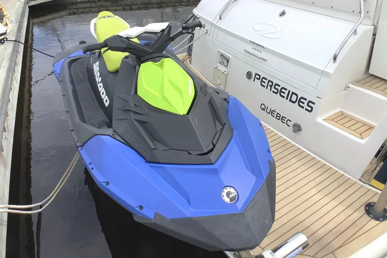 Perseides Yacht Photos Pics Blue and green Sea-Doo jet ski docked beside a 2005 Regal Commodore 3860 boat.