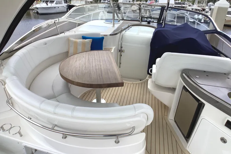 Perseides Yacht Photos Pics Luxurious 2005 Regal Commodore 3860 yacht interior with elegant seating and wooden table.
