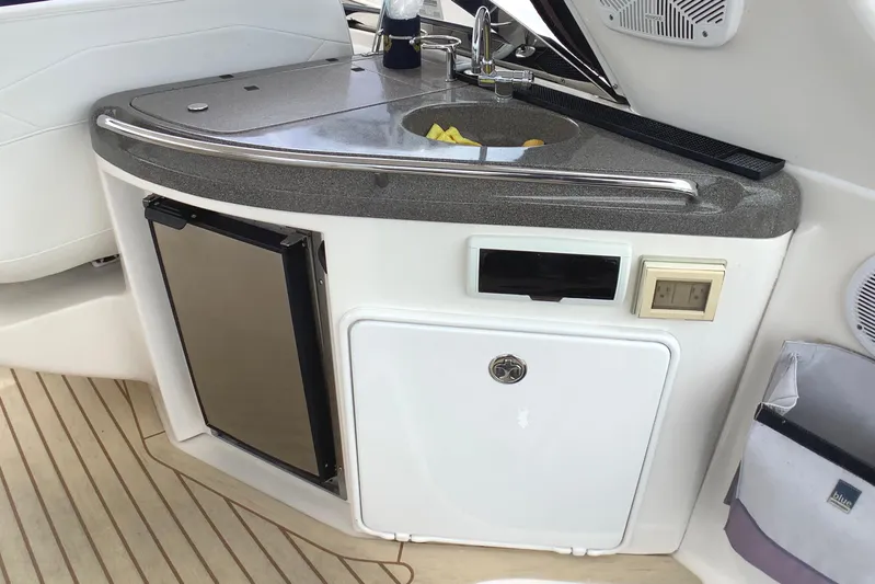 Perseides Yacht Photos Pics 2005 Regal Commodore 3860 yacht kitchenette with sink, mini fridge, and storage.