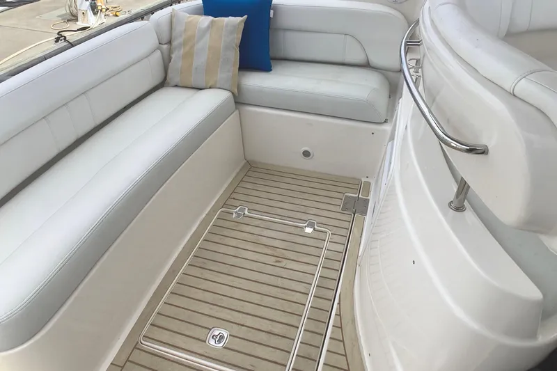 Perseides Yacht Photos Pics 2005 Regal Commodore 3860 yacht interior with white seating and striped cushions.