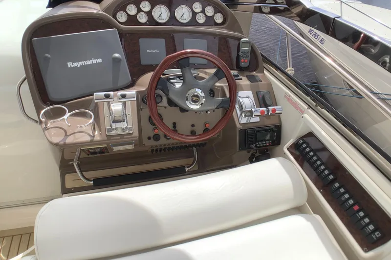 Perseides Yacht Photos Pics 2005 Regal Commodore 3860 helm with Raymarine electronics and wood-accented steering wheel.