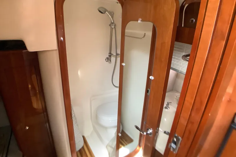 Perseides Yacht Photos Pics Luxurious bathroom in 2005 Regal Commodore 3860 yacht with shower and wooden accents.