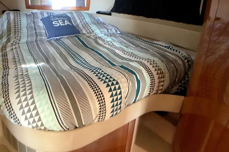 Perseides Yacht Photos Pics Cozy cabin bed in 2005 Regal Commodore 3860 yacht with patterned bedding.