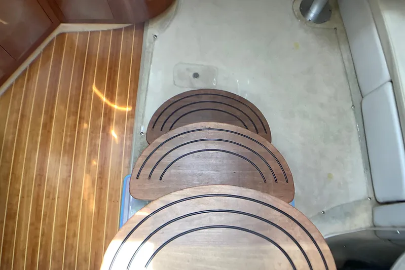 Perseides Yacht Photos Pics Wooden steps inside a 2005 Regal Commodore 3860 yacht, featuring elegant curved design.