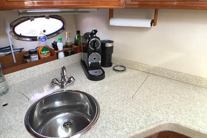 Perseides Yacht Photos Pics 2005 Regal Commodore 3860 yacht kitchen with sink, coffee maker, and countertop essentials.