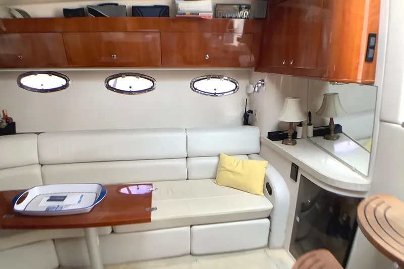 Perseides Yacht Photos Pics Luxurious 2005 Regal Commodore 3860 yacht interior with plush seating and elegant wood cabinetry.