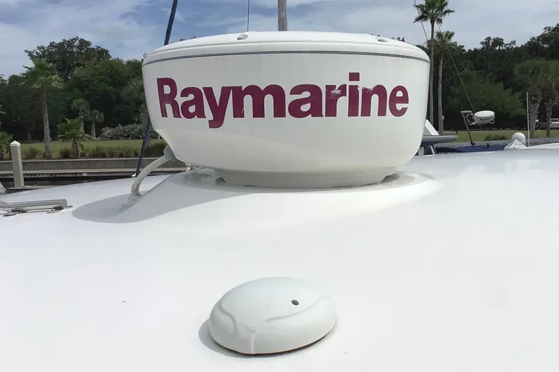 Perseides Yacht Photos Pics 2005 Regal Commodore 3860 with Raymarine radar on deck, surrounded by lush greenery.