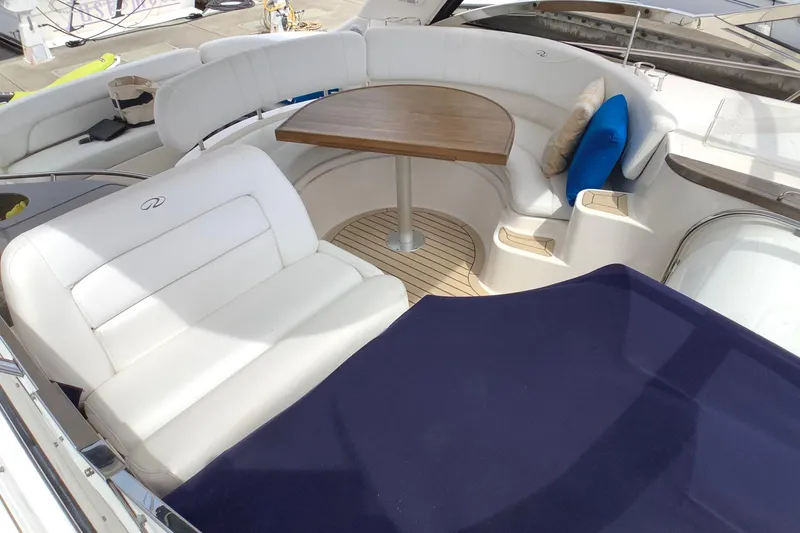 Perseides Yacht Photos Pics Luxurious seating area on a 2005 Regal Commodore 3860 yacht with wooden table.
