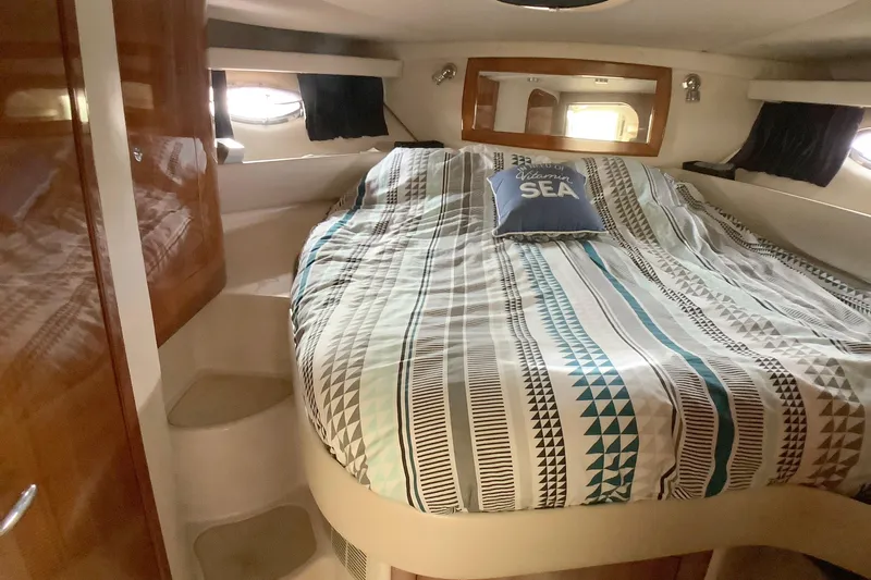 Perseides Yacht Photos Pics Cozy cabin interior of 2005 Regal Commodore 3860 yacht with patterned bedding.