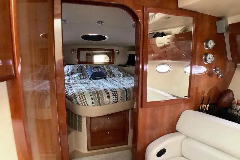 Perseides Yacht Photos Pics Luxurious cabin interior of 2005 Regal Commodore 3860 yacht with cozy bed and wooden finish.