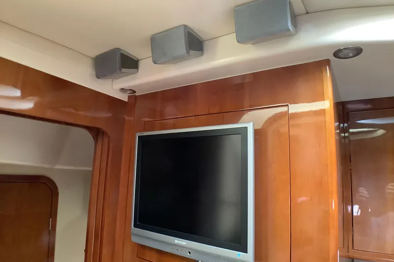 Perseides Yacht Photos Pics Flat-screen TV and speakers in 2005 Regal Commodore 3860 yacht interior.