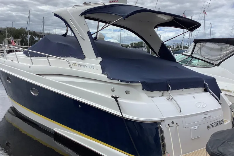 Perseides Yacht Photos Pics 2005 Regal Commodore 3860 yacht docked, featuring a blue and white exterior with covered deck.