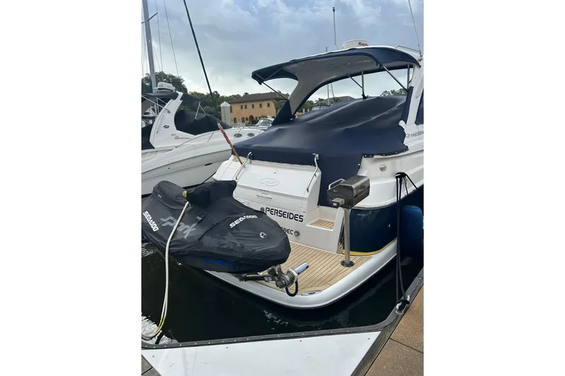 Perseides Yacht Photos Pics 2005 Regal Commodore 3860 yacht docked with covered jet ski on platform.