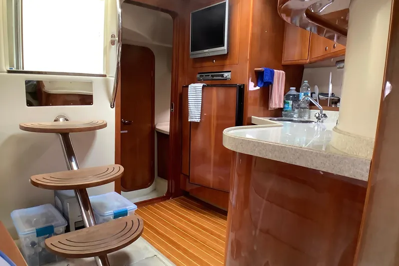 Perseides Yacht Photos Pics Interior of 2005 Regal Commodore 3860 yacht with wooden cabinetry and modern amenities.