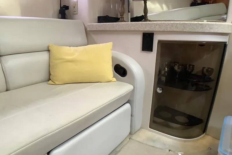 Perseides Yacht Photos Pics Interior of 2005 Regal Commodore 3860 yacht with beige seating and yellow pillow.