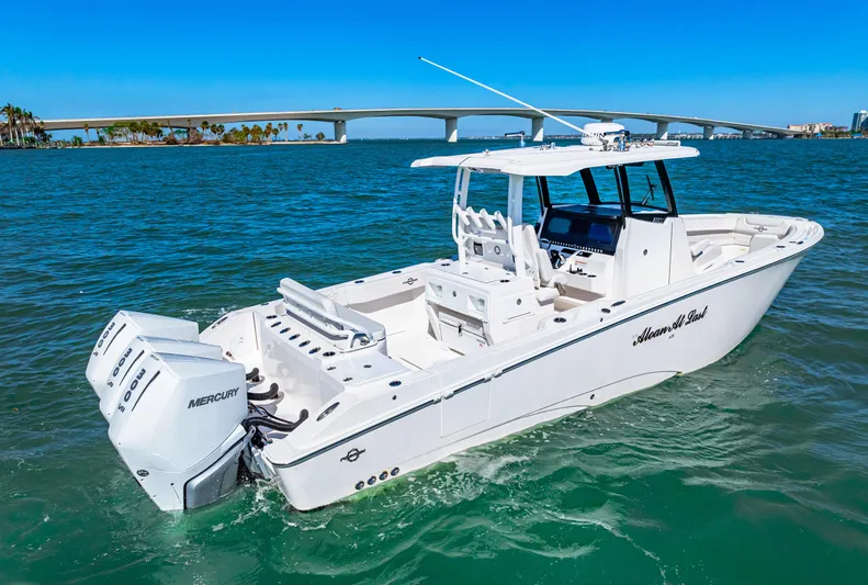 Tt Aloan At Last Yacht Photos Pics 2023 Fountain 32 NX boat on water with bridge in background.