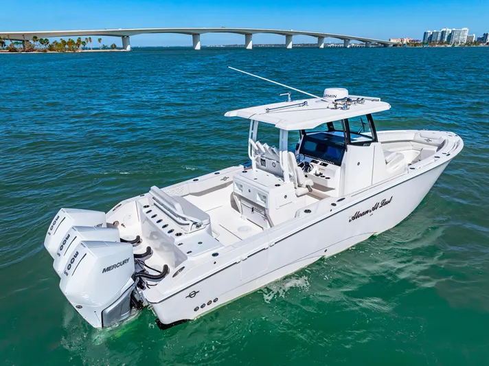 Tt Aloan At Last Yacht Photos Pics 2023 Fountain 32 NX boat on water with bridge in background.