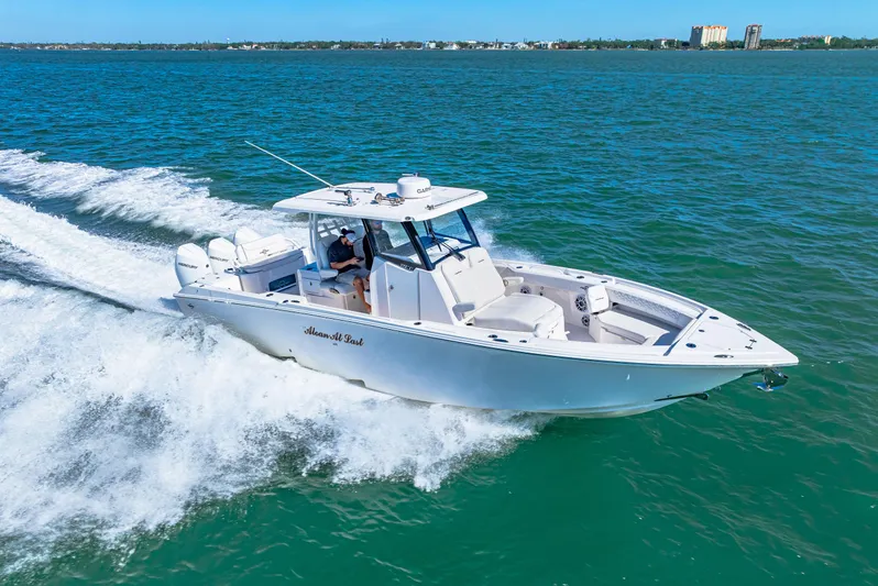 Tt Aloan At Last Yacht Photos Pics 2023 Fountain 32 NX boat cruising on open water.