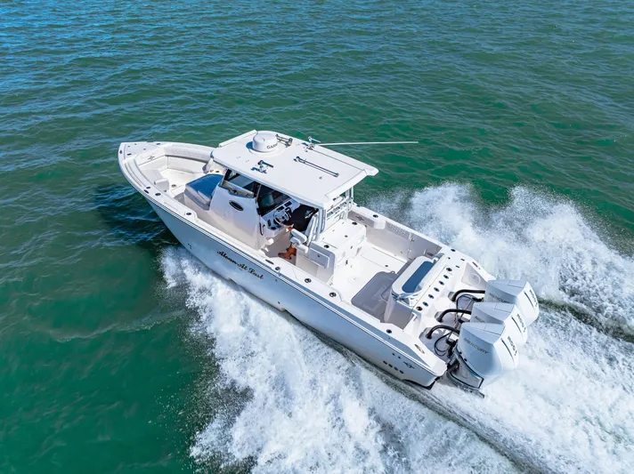 Tt Aloan At Last Yacht Photos Pics 2023 Fountain 32 NX boat cruising on open water.