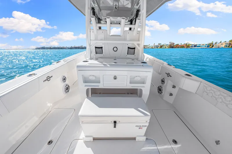 Tt Aloan At Last Yacht Photos Pics 2023 Fountain 32 NX boat interior with ocean view, featuring sleek white design.