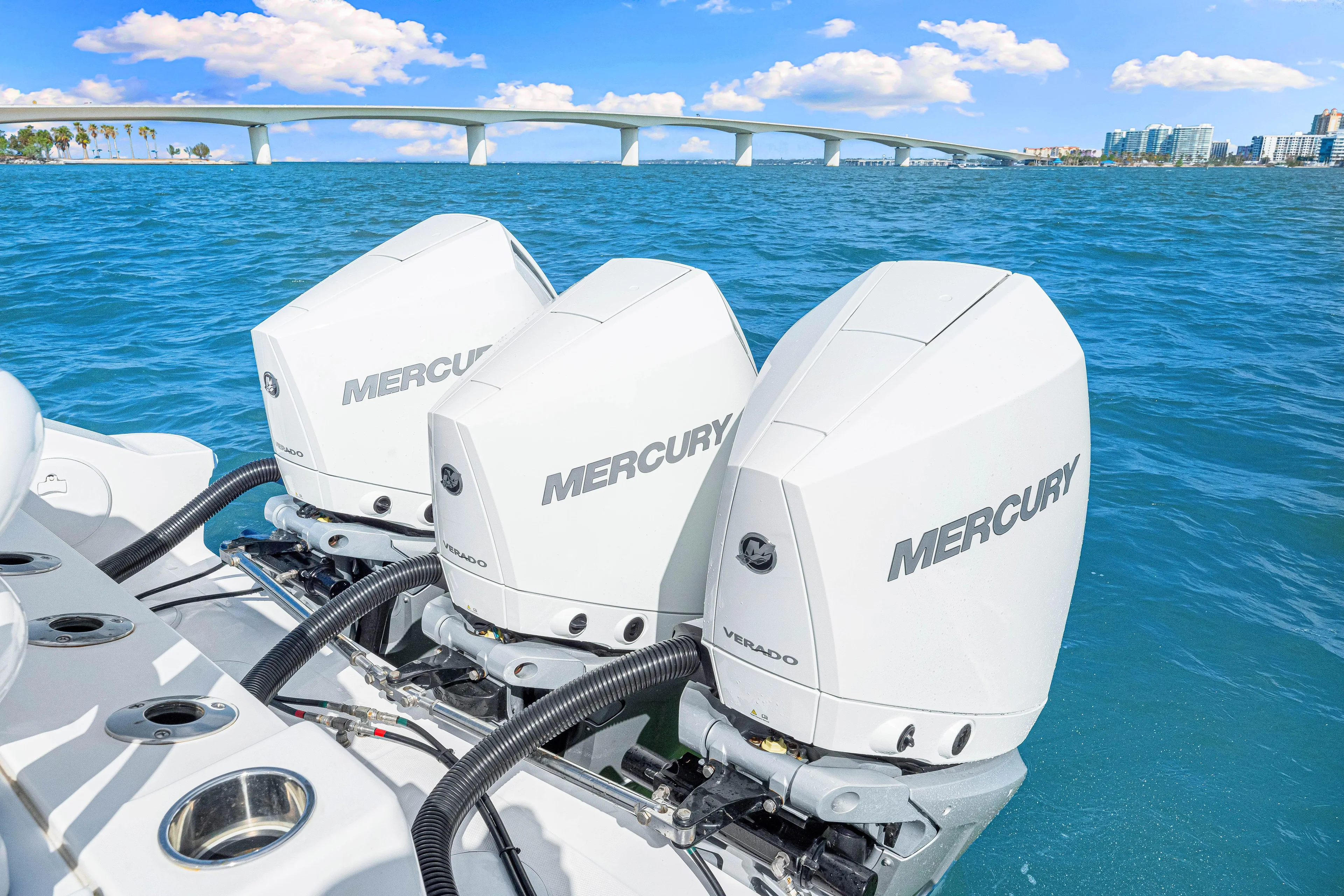 Tt Aloan At Last Yacht Photos Pics 2023 Fountain 32 NX boat with triple Mercury engines on blue ocean.