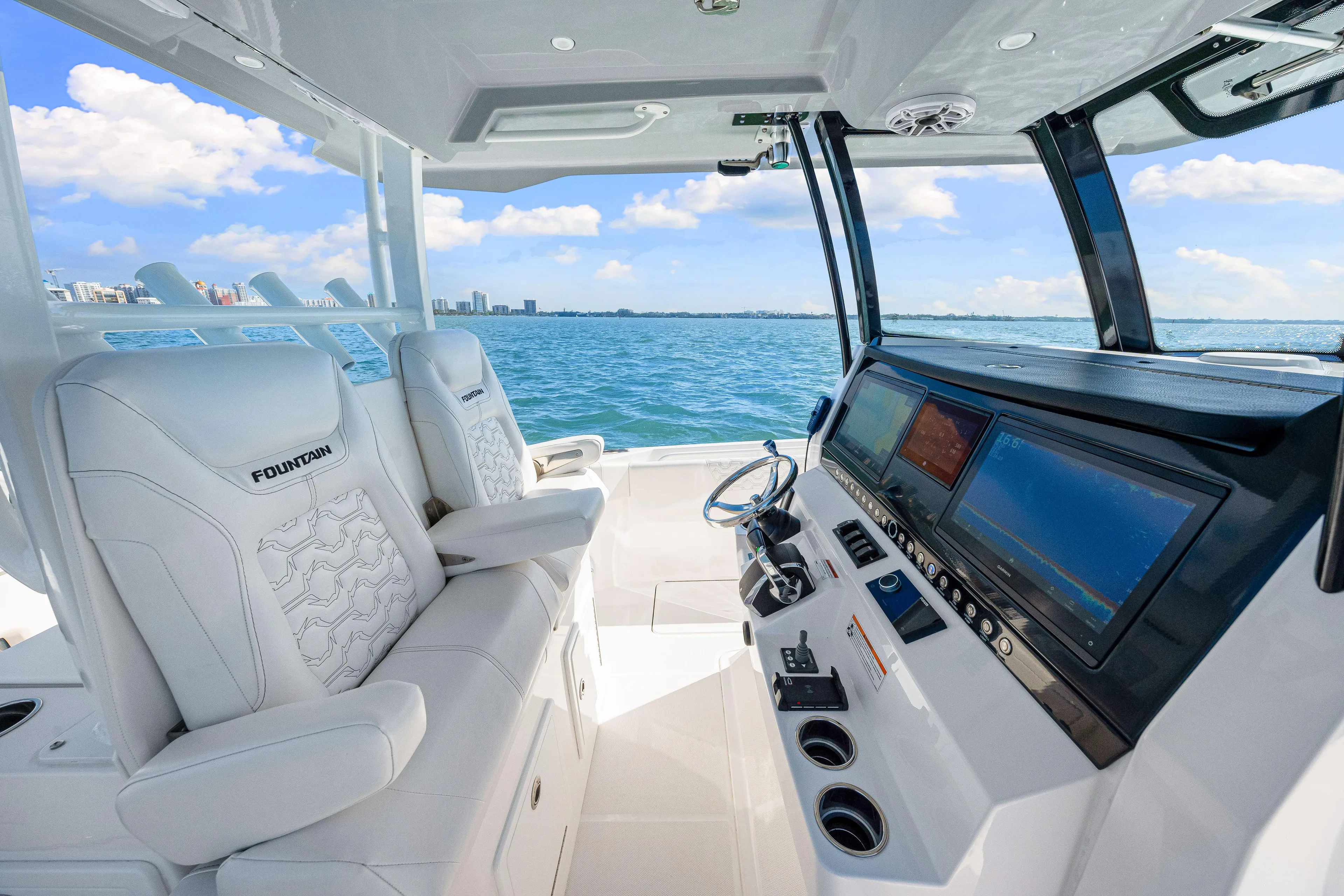 Tt Aloan At Last Yacht Photos Pics 2023 Fountain 32 NX boat interior with modern dashboard and ocean view.