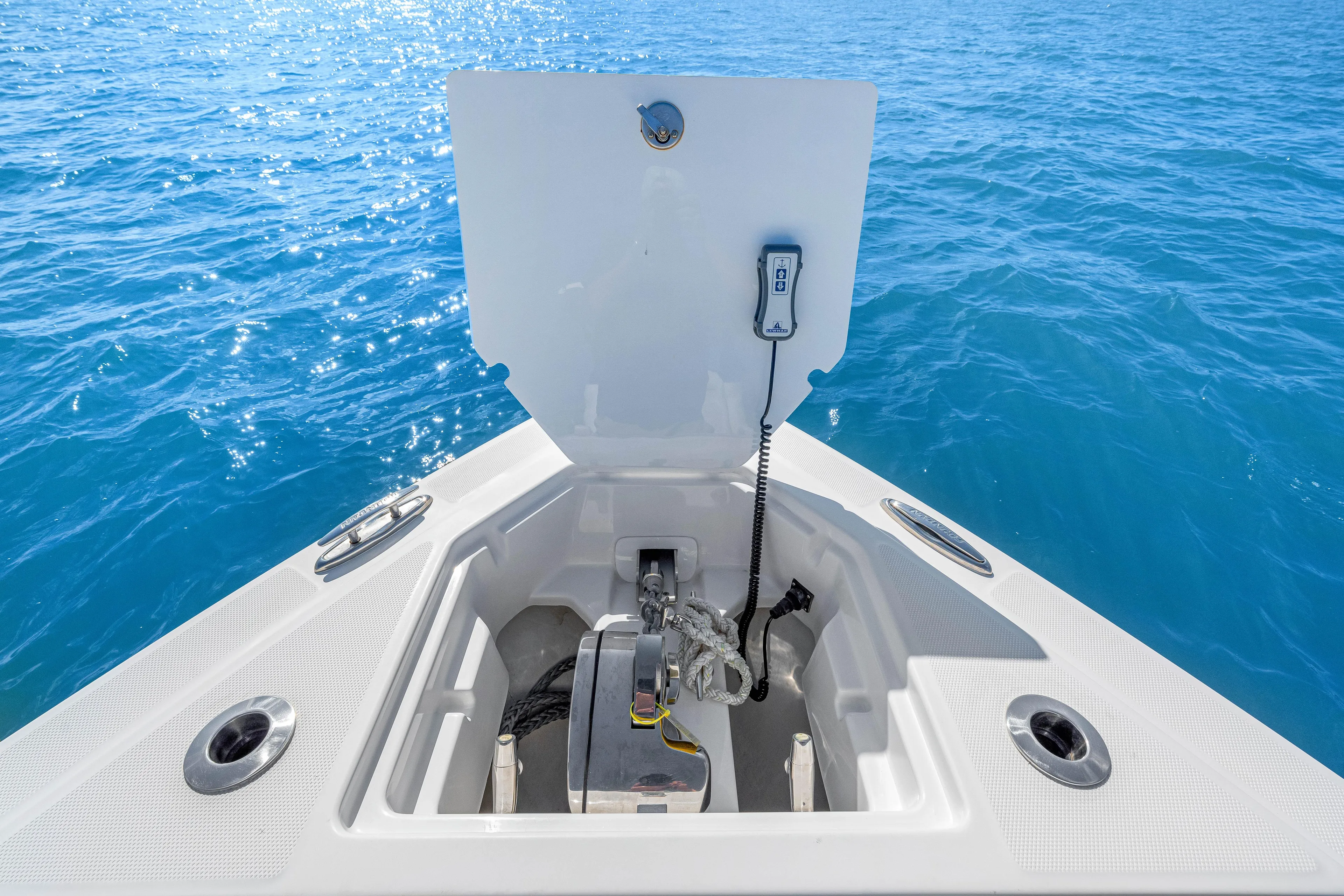 Tt Aloan At Last Yacht Photos Pics 2023 Fountain 32 NX boat anchor compartment on clear blue water.
