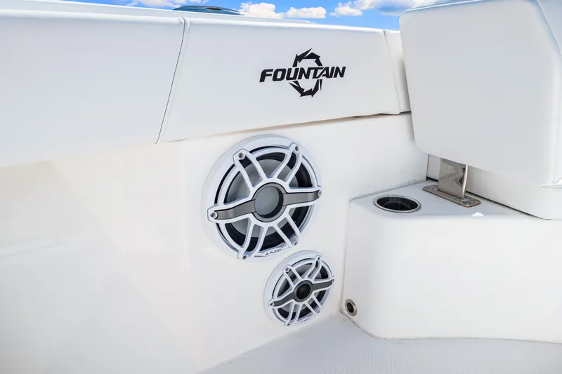 Tt Aloan At Last Yacht Photos Pics 2023 Fountain 32 NX boat interior with speakers and cup holder.