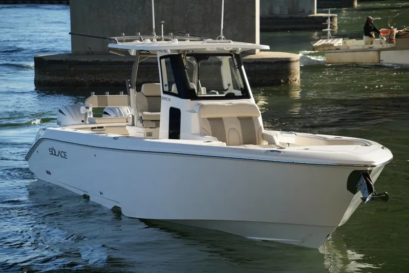  Yacht Photos Pics 2024 Solace 32 CS boat cruising on water near a bridge.