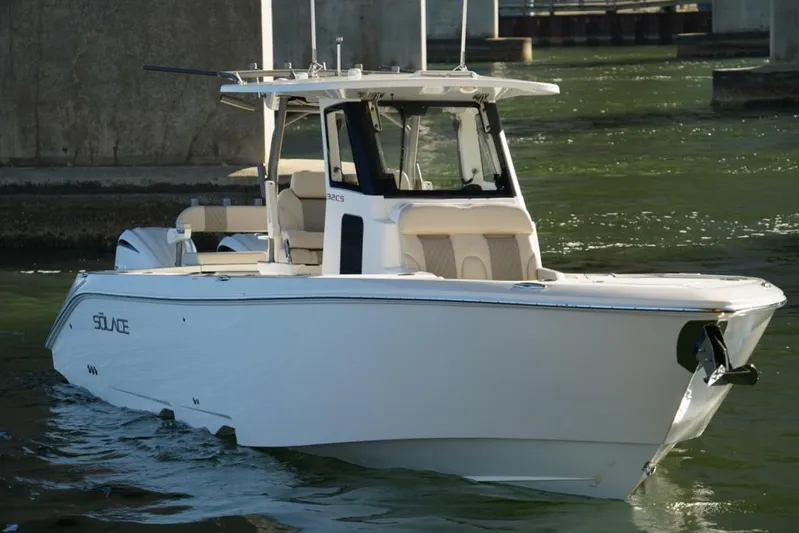  Yacht Photos Pics 2024 Solace 32 CS boat cruising on water under a bridge.