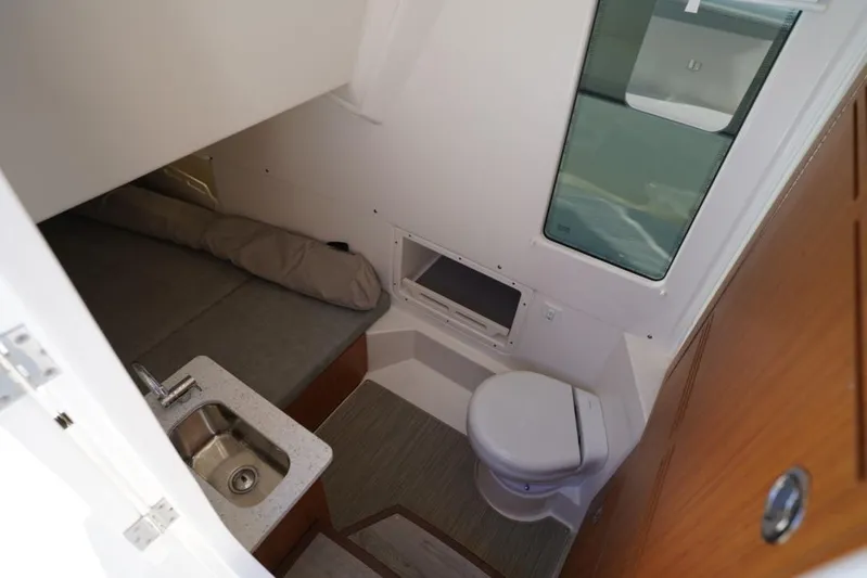  Yacht Photos Pics 2024 Solace 32 CS cabin interior with sink, toilet, and bed.