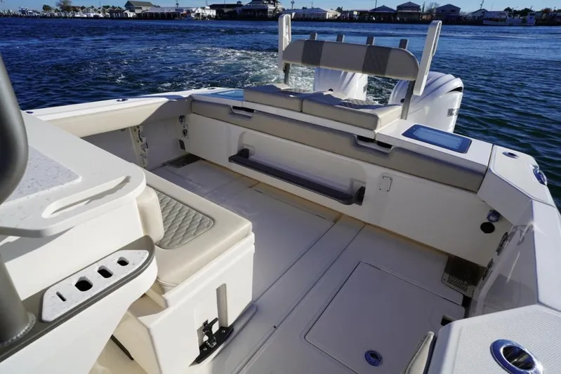  Yacht Photos Pics 2024 Solace 32 CS boat interior with seating and storage, on calm water.