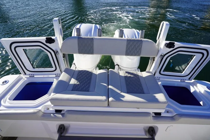  Yacht Photos Pics 2024 Solace 32 CS boat with cushioned seating and open storage compartments.