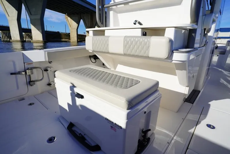  Yacht Photos Pics 2024 Solace 32 CS boat interior with cushioned seating and storage under a bridge.